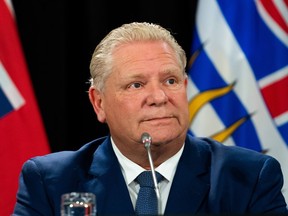Ontario Premier Doug Ford listens to members of the media during a press conference in Ottawa, on Tuesday, Feb. 7, 2023. Ford says his chief of staff received a briefing from the Canadian Security Intelligence Service after reports of election interference by China were tied to a member of his caucus.THE CANADIAN PRESS/Spencer Colby