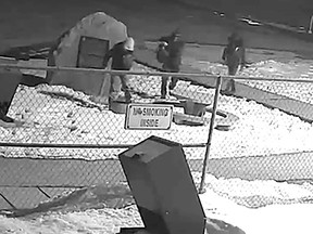 A surveillance still image from a security camera show individuals in front of the Hangar Flight Museum in Calgary. A number of the brass plaques were stolen late Monday/early Tuesday March 21/ 23. Courtesy Hangar Flight Museum