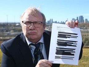 This file image shows Rick Bell holding a redacted copy of an Olympic document in Calgary on Wednesday, October 17, 2018.