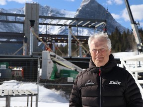 Norbert Meier stands in front of the construction of a new biathlon centre, part of the Canmore Nordic Centre's $17 million in upgrades to ensure its World Cup host status on Friday March 31, 2023. The upgrades also include the day lodge building and the expansion of the Frozen Thunder snow farm. All upgrades are to be completed by the end of 2023 and will continue to build on the legacy of this 1988 Winter Olympics facility.