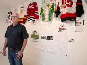 Rob Muench, then mayor of Humboldt, Sask., stands for a photograph with some non-monetary donations received in the months since the Broncos bus crash in April 2018.