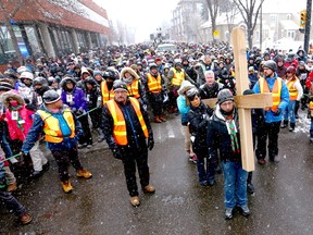 The Way of the Cross proceeds down 2 St. S.W. with hundreds of supporters in downtown Calgary on Friday, March 30, 2018. The event moves to Our Lady of Fatima parish in southeast Calgary in 2023.