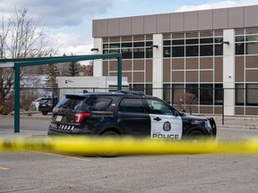 Calgary police tape off an area in the parking lot of a commercial complex on 1 St. S.W. on Wednesday, April 12, 2023.