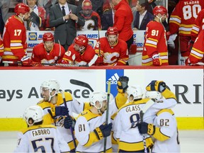 A dejected Calgary Flames bench watches as the Nashville Predators celebrate their shoot out victory at the Scotiabank Saddledome on Monday, April 10, 2023.