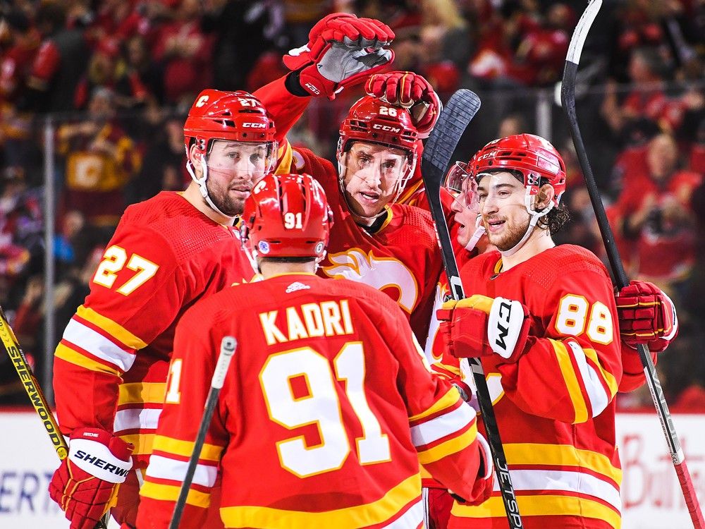 Calgary Flames defenceman Michael Stone (centre) celebrates with teammates after scoring the game-winning goal against the Anaheim Ducks at the Scotiabank Saddledome on Sunday, April 2, 2023.