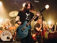 Taylor Hawkins, Dave Grohl and Nate Mendel of Foo Fighters perform onstage at the after party for the Los Angeles premiere of Studio 666, at the Fonda Theatre in Hollywood.