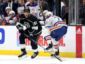 Quinton Byfield of the Los Angeles Kings stickhandles away from Vincent Desharnais of the Edmonton Oilers during the second period in Game Three of the First Round of the 2023 Stanley Cup Playoffs at Crypto.com Arena on April 21, 2023 in Los Angeles, California.