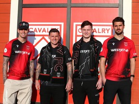 Cavalry FC players, from left, Myer Bevan, Fraser Aird, Gareth Smith-Doyle and Charlie Trafford pose wearing the team’s new 2023 kit unveiled at Kildares Ale House in Calgary on April 5, 2023.