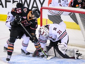 Calgary Hitmen forward Maxim Muranov tries to stuff the puck past Red Deer Rebels goaltender Kyle Kelsey at the Scotiabank Saddledome in Calgary on Monday, April 3, 2023.