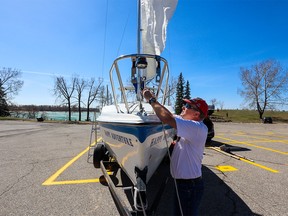 Neil Vivian prepares his sailboat Happy Adventure at the Heritage Park boat launch on Sunday, April 30, 2023. Happy Adventure is named after 17th Century English pirate Peter Easton’s ship. The Glenmore Reservoir opens to boats on Monday May 1. Calgary sailors can look forward to warm sunny skies this week.