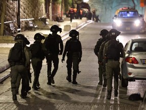 Israeli border guards patrol outside the Al-Aqsa Mosque compound at Lion's Gate in Jerusalem's Old City during clashes with Palestinians in Al-Aqsa Mosque, early Wednesday, April 5, 2023.