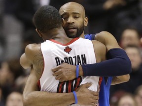 DeMar DeRozan and Vince Carter share a hug.