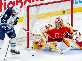 Calgary Wranglers goaltender Dustin Wolf, pictured during a game against the Manitoba Moose, is the first back-to-back winner of the Aldege ‘Baz’ Bastien Memorial Award since its inception in 1984.