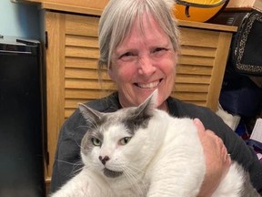 Kay Ford meeting Patches, a 40-pound cat, for the first time. Ford adopted Patches from Richmond Animal Care and Control on April 19. MUST CREDIT: Richmond Animal Care and Control photo