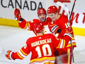Calgary Flames defenceman Nikita Zadorov (right) celebrates his hat-trick goal against the San Jose Sharks at the Scotiabank Saddledome in Calgary on Wednesday, April 12, 2023.