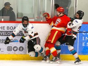 The Calgary NW Flames’ Aidan LaRose battles the Okanagan Rockets’ Kaiden Schaupmeyer during the U18AAA Pacific Region final at Father David Bauer Arena in Calgary on April 7, 2023.