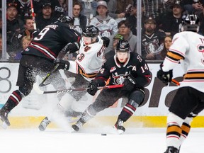 The Calgary Hitmen 
and the Red Deer Rebels battle for the puck during a 6-5 overtime win for the Rebels. The Rebels completed a 4-1 series win to move on to the second-round of the WHL playoffs.  Rob Wallator/ Red Deer Rebels