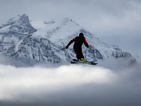 A skier floats above the clouds after hitting one of the many jumps in the Boulevard Terrain Park at Lake Louise ski resort. AL CHAREST / POSTMEDIA