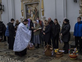 Orthodox Christian worshipers and their traditional Easter baskets are blessed during Easter Sunday at the Pechersk Lavra monastic complex Kyiv, Sunday, April 16, 2023.