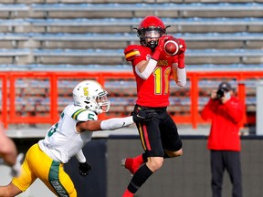Calgary Dinos receiver Nathanael Durkan makes a catch while being defended by Alberta Golden Bears defensive back Tyshon Blackburn at McMahon Stadium in Calgary on Oct. 24, 2021.