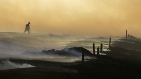 Fire has long been both friend and foe to humankind, with blazes leaving their mark on the history of prairie provinces. Pictured is a firefighter who was part of a team that controlled a wildfire outside of Regina in April 2016.