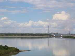 Syncrude Mildred Lake site is seen across from Base Mine Lake, which is a former tailings pond, as seen from the Syncrude Bison Ranch Viewpoint on June 11, 2022.
