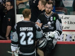 Calgary Roughnecks Shane Simpson consoles Jesse King after their team's NLL season ended with a loss against the Colorado Mammoth during the third game of conference finals at Scotiabank Saddledome on Saturday, May 20, 2023.