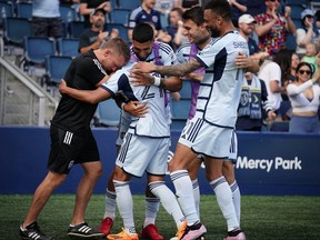 Sporting Kansas City midfielder Felipe Hernandez (21) celebrates with teammates after a goal against the Portland Timbers.