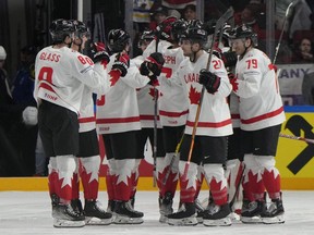 Team Canada players celebrate after defeating Slovakia.