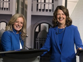 Alberta NDP leader Rachel Notley and UCP leader Danielle Smith shake hands as they pose for a photo prior to their debate at CTV Edmonton, Thursday May 18, 2023.