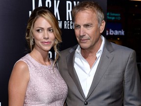 Actor Kevin Costner and Christine Baumgartner attend the premiere of Paramount Pictures' "Jack Ryan: Shadow Recruit" at TCL Chinese Theatre on January 15, 2014 in Hollywood, California.