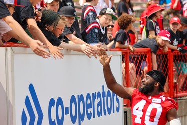 Calgary Stampeders defensive back Marc-Sullivan Andzang has some fun with fans before a preseason game between the Calgary Stampeders and Edmonton Elks on Monday, May 22, 2023.  
Gavin Young/Postmedia