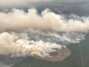 FILE PHOTO: Smoke rises from wildfire EWF-031, part of the Pembina Wildfire Complex east of Minnow Lake near Edson, Alberta, Canada on May 19, 2023.