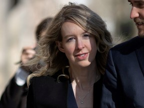 Theranos founder Elizabeth Holmes arrives at the federal courthouse accompanied by her partner Billy Evans, to ask a U.S. judge at a hearing to pause her prison sentence of more than 11 years while she urges an appeals court to review her conviction on charges of defrauding investors in the blood testing startup at the federal courthouse in San Jose, Calif., March 17, 2023.