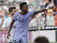 Real Madrid's Brazilian forward Vinicius Junior reacts to being insulted pointing at the stands during the Spanish league football match between Valencia CF and Real Madrid CF at the Mestalla stadium in Valencia on May 21, 2023. Spanish prosecutors opened a probe on May 22, 2023 into racist chants aimed at Real Madrid's star forward Vinicius Junior during a match as the football federation president admitted the country had a "problem" with racism.