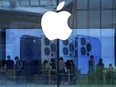 People shop at an Apple Store in Beijing, Tuesday, Sept. 28, 2021.