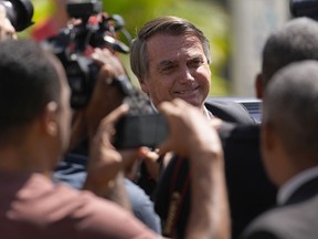 Former Brazilian President Jair Bolsonaro leaves Federal Police headquarters after giving testimony over the Jan. 8 attacks in Brasilia, Brazil, Wednesday, April 26, 2023.