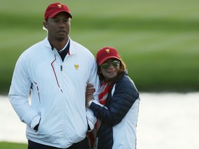 Captain's assistant Tiger Woods of the U.S. Team and Erica Herman look on during Saturday four-ball matches of the Presidents Cup at Liberty National Golf Club on September 30, 2017 in Jersey City, New Jersey. (Rob Carr/Getty Images)