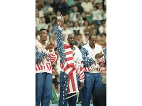 FILE - United States' Scottie Pippen, left, Michael Jorden, center, and Clyde Drexler rejoice, Aug. 8, 1992, with their gold medals after beating Croatia, 117-85, in Olympic basketball in Barcelona, Spain. The jacket that Jordan famously wore but covered the Reebok logo of at the 1992 Barcelona Olympics will be offered at auction by Sotheby's in June 2023.