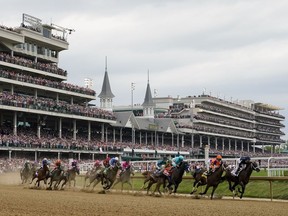 Horses come through the first turn during the Kentucky Derby at Churchill Downs on May 6, 2023, in Louisville, Ky.