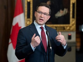 Conservative Leader Pierre Poilievre responds to a reporter's question in the foyer of the House of Commons, in Ottawa on Feb. 21, 2023.