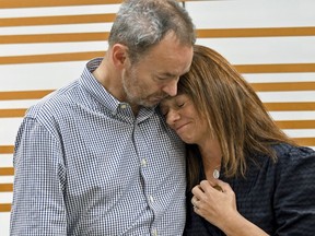 Simon and Sally Glass comfort each other during an emotional news conference in Denver on Tuesday, Sept. 13, 2022.
