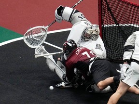 Colorado Mammoth defender Jalen Chaster, runs into Calgary Roughnecks goalie Christian Del Bianco during Game 1 West Conference final at Ball Arena in Denver on Thursday, May 11, 2023.