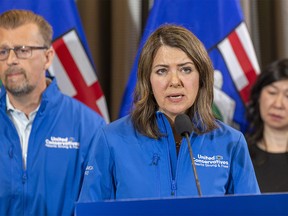 Danielle Smith, Leader of the United Conservative Party makes an announcement to improve public safety as Mike Ellis, UCP candidate for Calgary West and Holly Mah, chairwoman of the Chinatown Business Association, listen on Tuesday, May 9, 2023 in Edmonton.