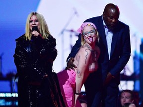 Avril Lavigne confronts topless environmental protester Casey "Ever" Hatherly as she presents during the Juno Awards on March 13, 2023.
