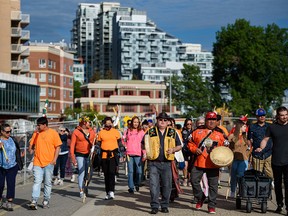 Participants on the Walk for Reconciliation proceed along Bow River pathway on National Indigenous Peoples Day on Tuesday, June 21, 2022.