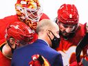 Then-assistant coach Ryan Huska of the Calgary Flames talks with his players during a time-out in an NHL game against the Winnipeg Jets at the Scotiabank Saddledome on February 9, 2021.