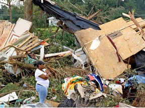 Dana Jackson stands outside her cousin Adrian Cole's tornado-damaged home home on June 19, 2023 in Louin, Mississippi. There were multiple confirmed tornadoes overnight in Mississippi that left at least one person killed and 25 injured during the storms.