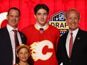 Samuel Honzek poses for a photo with Calgary Flames general manager Craig Conroy (left) and president of hockey operations Don Maloney after being selected 16th overall during the NHL Draft at Bridgestone Arena in Nashville on June 28, 2023.