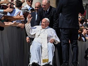 Pope Francis waves to attendees as he leaves at the end of the weekly general audience on June 7, 2023 at St. Peter's square as in The Vatican.